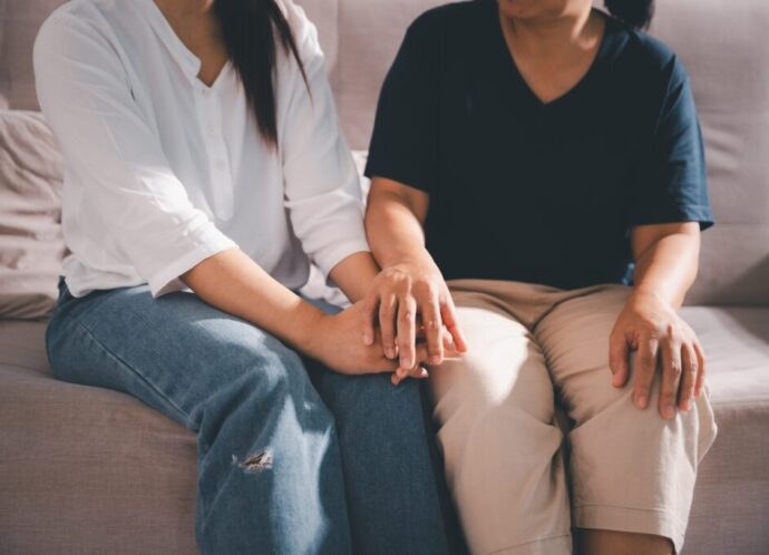 Moment of deep grief, sorrow and anxiety, lonely person overwhelmed by despair feels spark of hope when helping hand reaches out with genuine emotion to ease their problem.